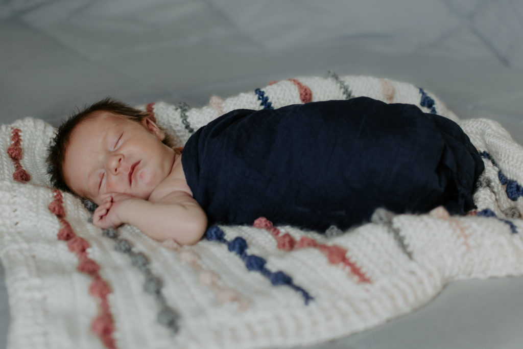 Newborn on handmade, crocheted blanket