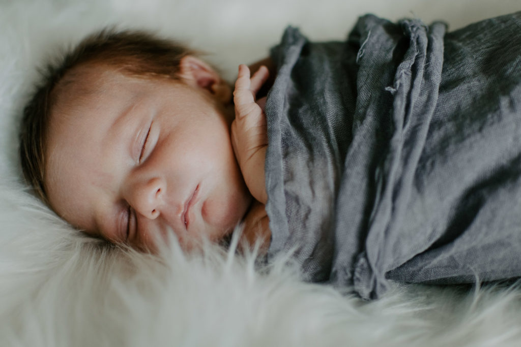Newborn on fuzzy blanket in Loveland, Colorado