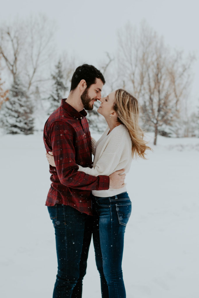 Snuggling in snowy Northern Colorado during engagement session