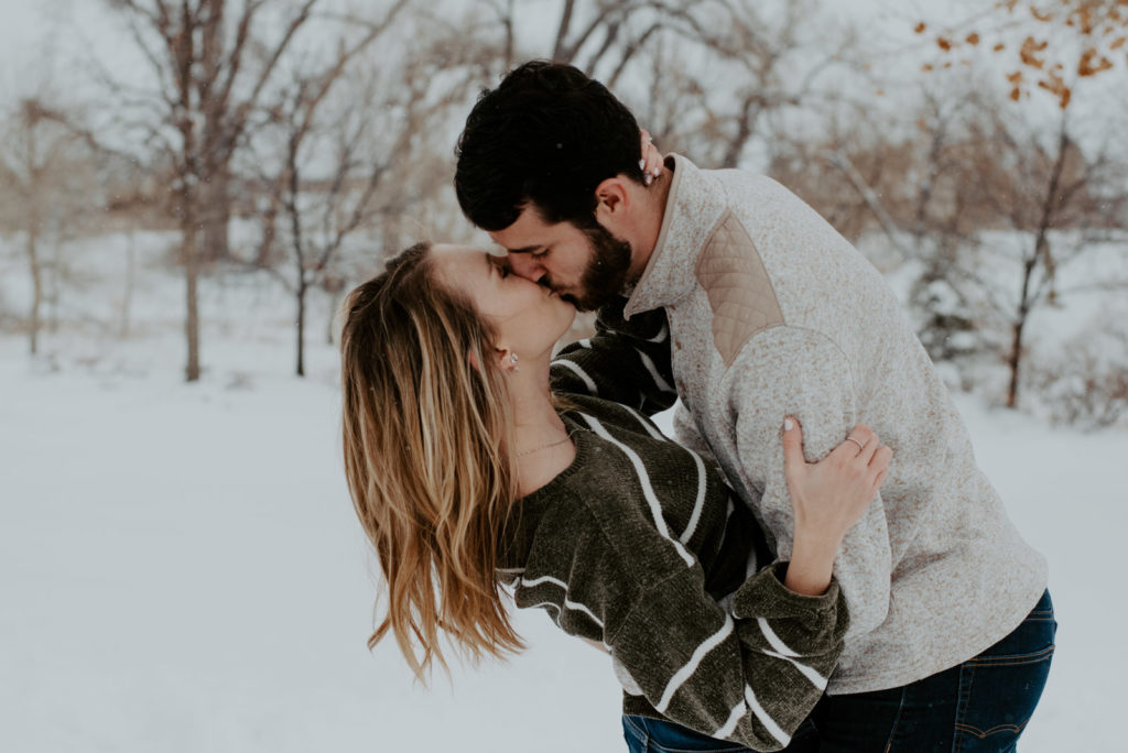 Kissing in the snow in Northern Colorado engagement photos