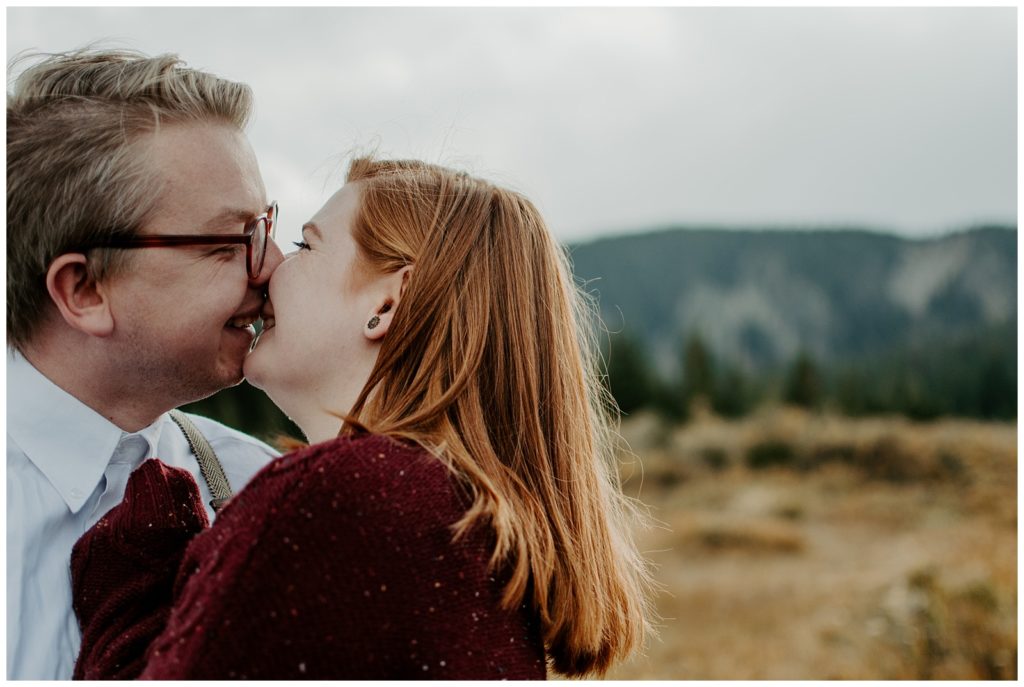 Couple kisses on a chilly fall day at Brainard lake during engagement photos