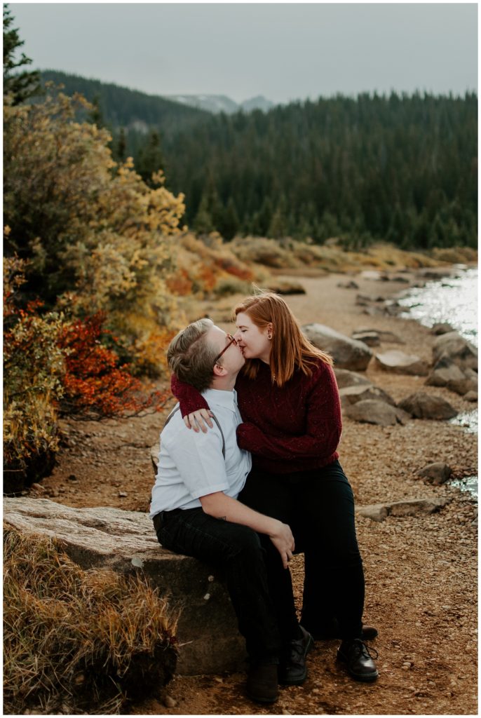 Couple kisses on the shore of Brainard Lake during engagement photos