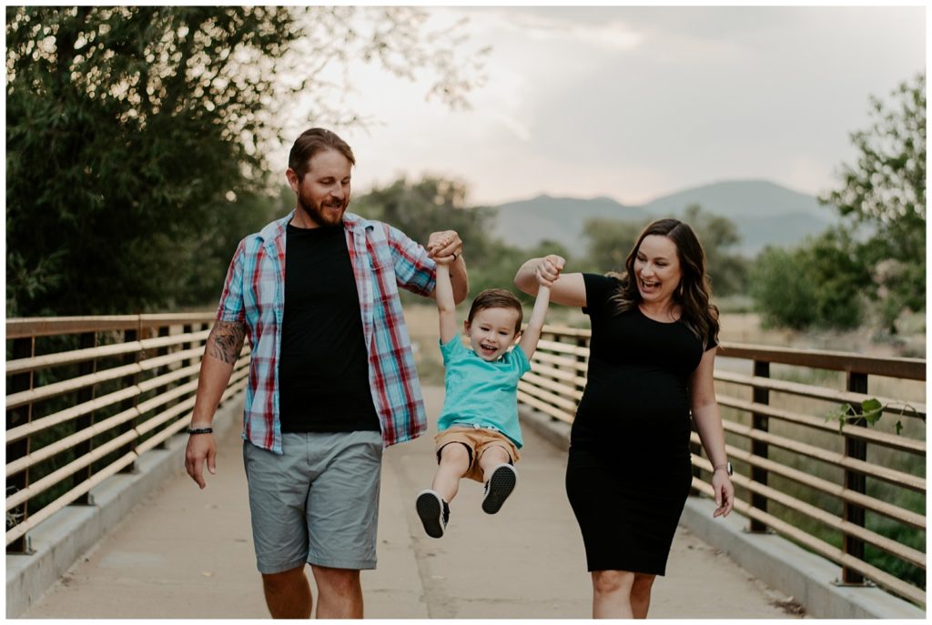 Family enjoys a walk with mountain views during Northern Colorado family photos