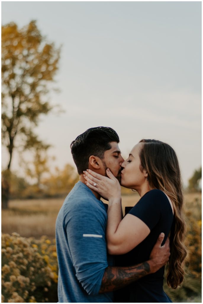 Fall kisses during engagement photo shoot 