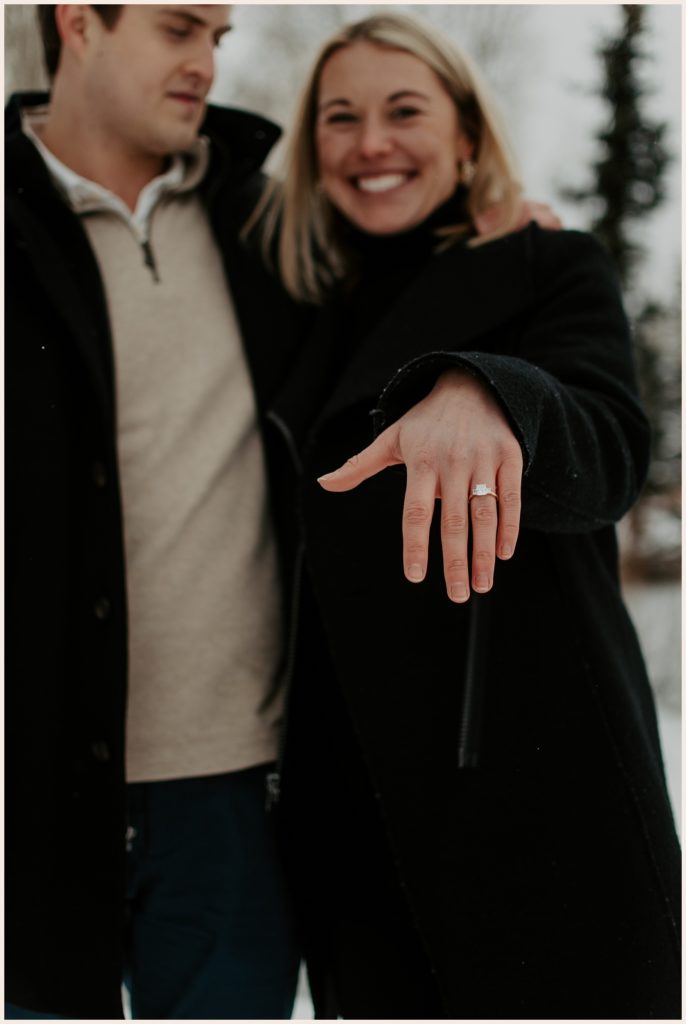 Showing off engagement ring during Colorado mountain proposal