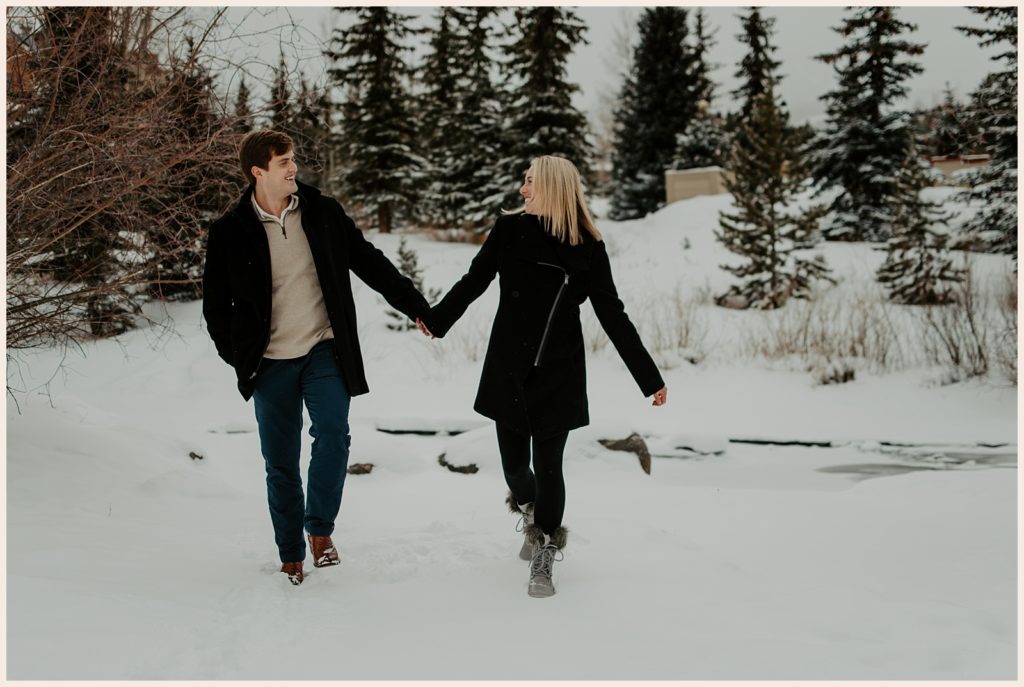 Couple walks through the snow during winter in Breckenridge