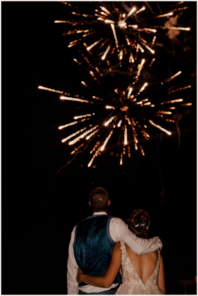 Couple watches a firework show at their outdoor wedding in Colorado