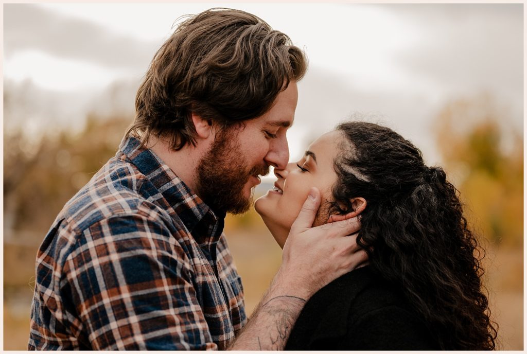 Couple kisses during fall engagement photos Colorado