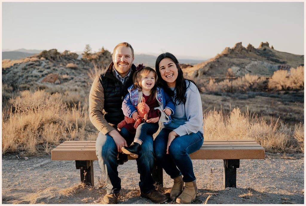 Family sits on a bench in Northern Colorado for their family photos