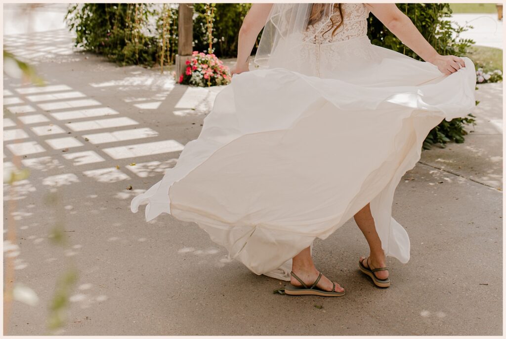 Brides dress flows around her as she twirls at her Brookside Gardens wedding 