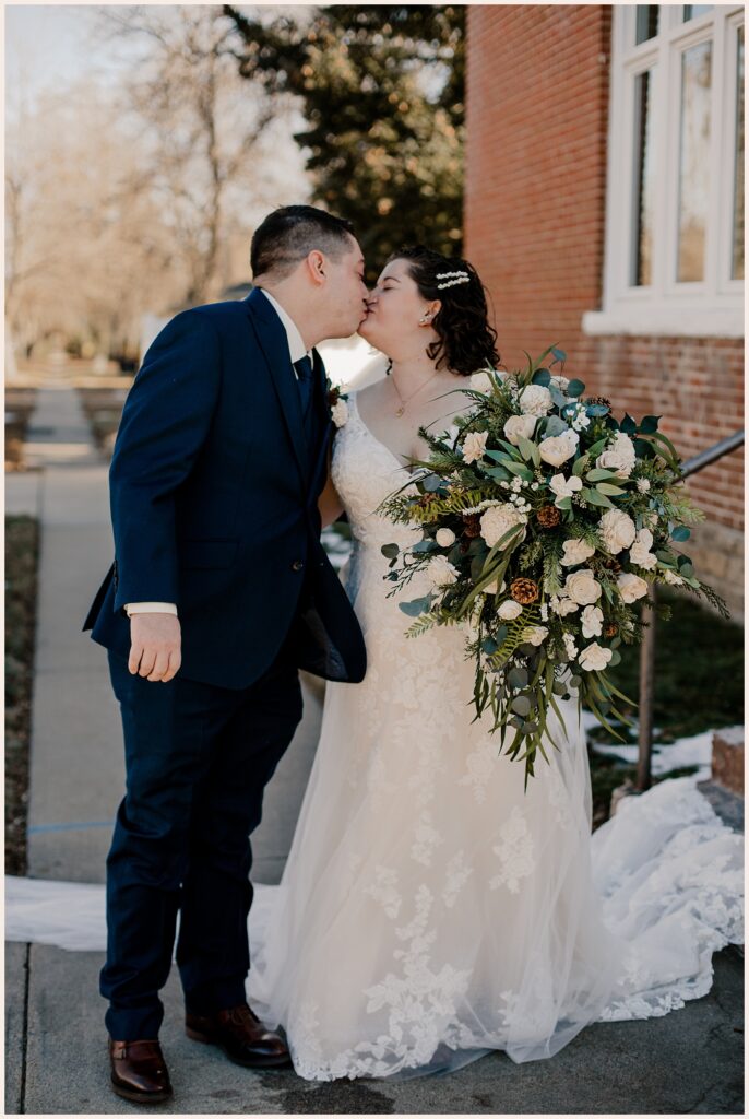 Couple kiss after their first look at their Sweetheart Winery wedding 