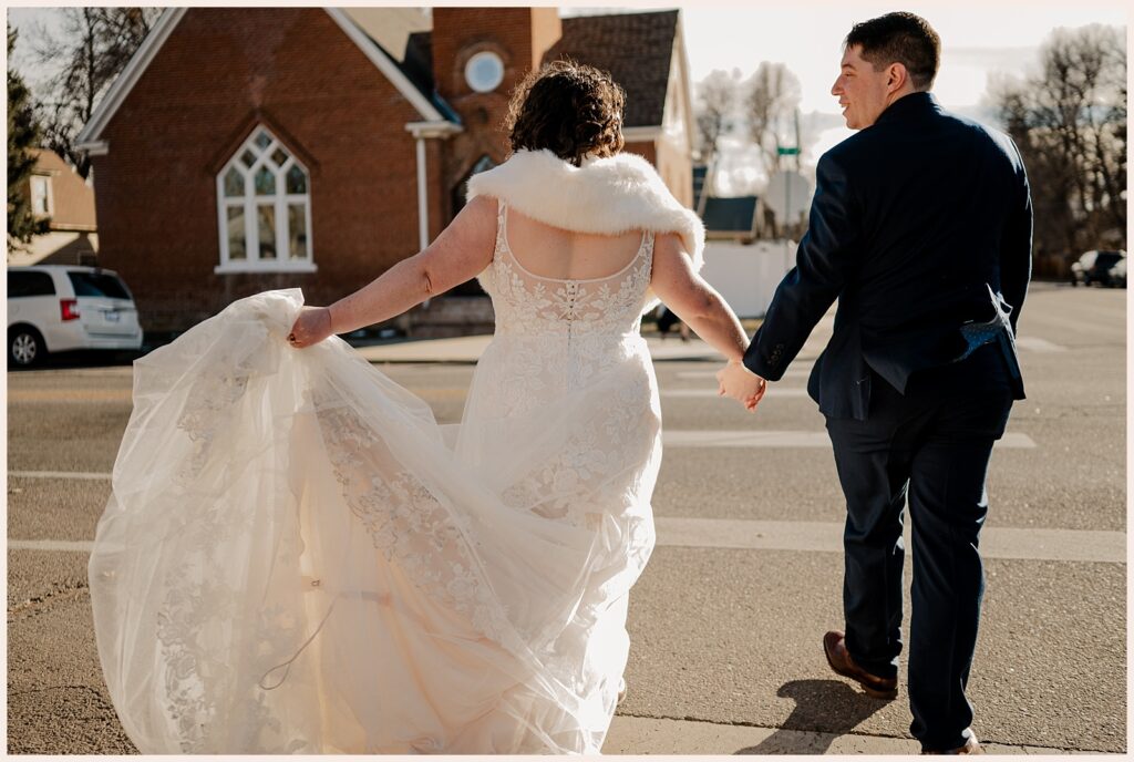 Couple crosses the street hand in hand during their Sweetheart Winery Wedding 