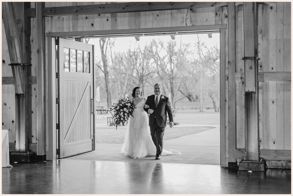 Bride and father walk into the ceremony during their Sweetheart Winery wedding 