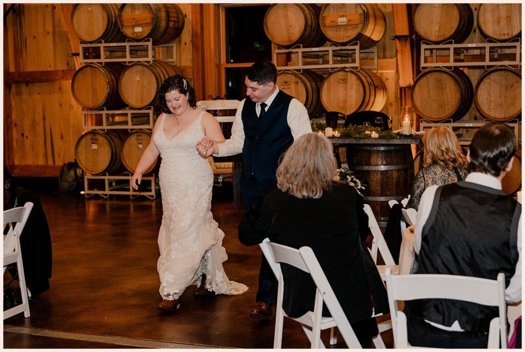 Couple walks onto the dance floor for their first dance at their Sweetheart Winery wedding 